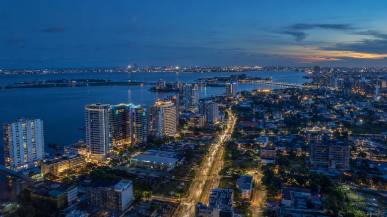 Aerial evening view of Victoria Island, Lagos, showing illuminated buildings, roads, and surrounding waterways.