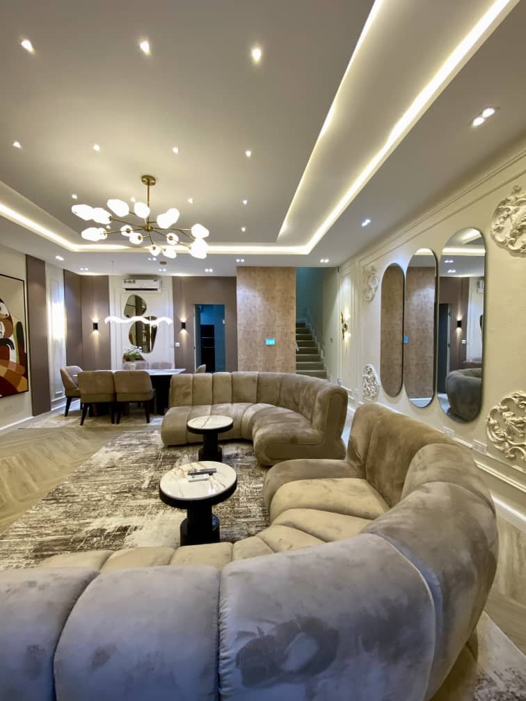 Modern luxury living room in a four-bedroom terrace duplex with elegant sofas, stylish lighting, and contemporary décor.