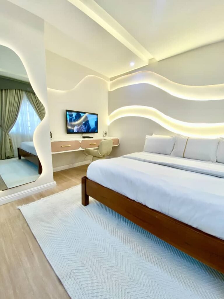 Bright modern living room with sectional sofa in a balcony one-bedroom apartment in Lekki Phase 1