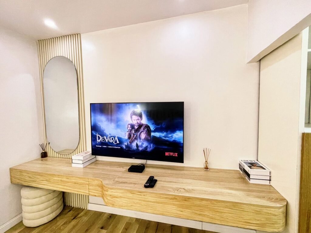 Wall-mounted smart TV and media console in a modern one-bedroom apartment in Lekki Phase 1